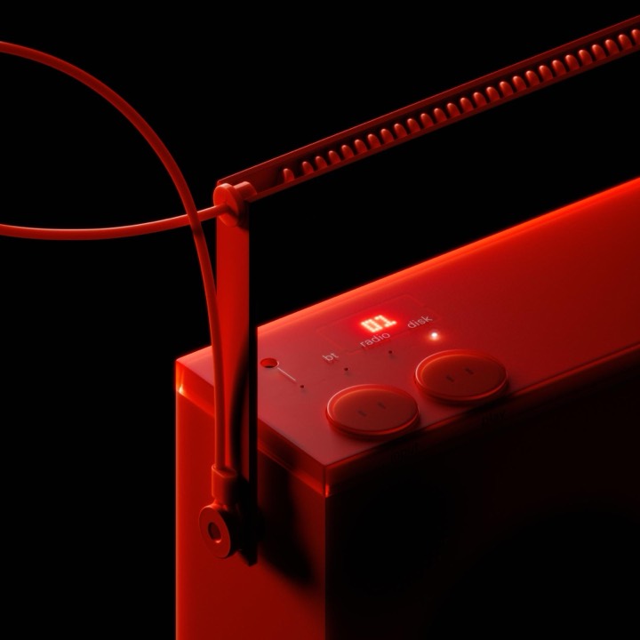 Monochrome red audio device render where dot-matrix display and glow do all the work against pure black, useful for single-hue product lighting.