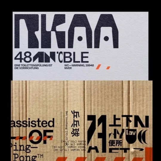 Modular slab display type mashed with Latin, CJK and hazard stripes, printed on cardboard and grey stock for a shipping-label look.
